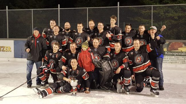 Eishockeyteam in schwarzen Trikots feiert Sieg beim Westallgäu Cup 2019/2020 auf dem Eisplatz Lindenberg.