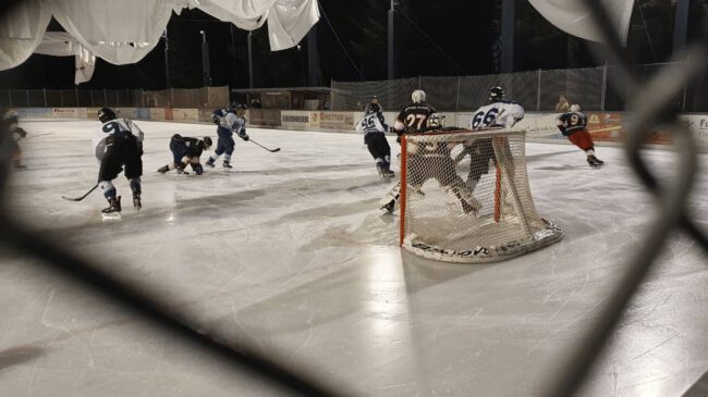 Eishockey-Spiel auf dem Eisplatz Lindenberg während der Playoffs 2023, Spieler kämpfen um die Scheibe vor dem Tor.